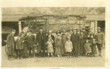 Men in military uniforms and women and children posing in front of a bus, Early, Iowa, 1910s
