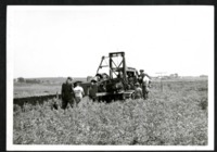 Men Work on a Dozer in a Field