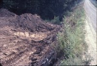 Bulldozed earth near gravel road