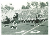 Scottish Highlanders and University of Iowa marching band performing at Rose Bowl, Pasadena, Calif., January 1957