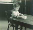 Toddler playing with a puzzle, The University of Iowa, 1920s
