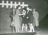 Homecoming queen Jody Dondore presenting award, 1955