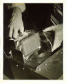 Engineering student handling fragile equipment in a laboratory, The University of Iowa, 1939