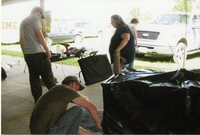 2010  Fair Booth Display table being set up by Caleb Waters, Mark Delperdang, and Jamie Grimes