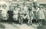 Small children standing in front of porch steps, The University of Iowa, 1920s