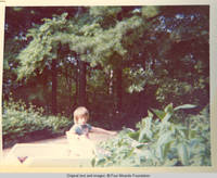 John, Jr. driving golf cart on lane
