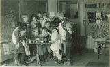 School children preparing food in class, The University of Iowa elementary school, 1920s