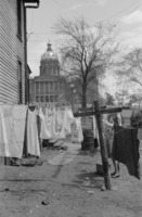 Woman hanging clothes at her home near the statehouse. 