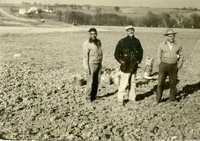 Peterson, Maddy, Moldenhauer standing in uncultivated land, 1959