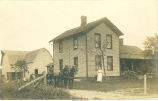 Man in horse-drawn wagon and woman on Robinson farm, Iowa, 1910s