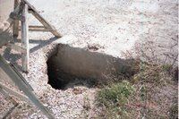1990s Hole in concrete on road