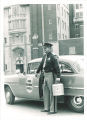 Patrolman Joe Smith delivering eye to hospital for transplant, The University of Iowa, 1958