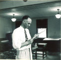 Man reading in a pharmacy school office, The University of Iowa, 1940s