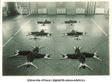 Students in gymnasium doing floor exercises, The University of Iowa, 1930