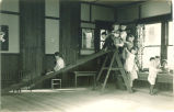 Children playing on an indoor slide, The University of Iowa, ca. 1920