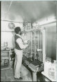 Researcher adjusting dial control, 1976