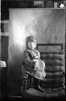 UP611 Child sitting on arm of chair
