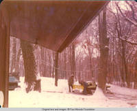 Two unknown men working on snow plow