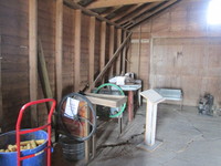 024. Corn sheller with blue tub of corn to the left of it