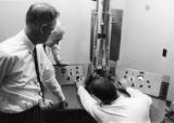 C. Clark Bowen, Dean Bear, and Dean Andre with the electron microscope