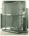 Engineering student working with airplane engine in engineering laboratory, The University of Iowa, 1939