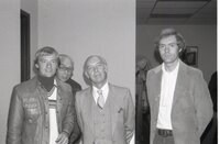 1980 Four men pose for picture at a meeting