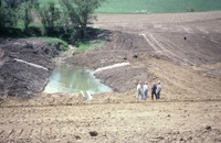 Bulldozed area with men 