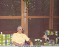 Bill and John, Jr. sitting in the screened in porch 