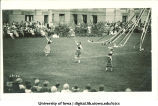 Women in ethnic costume dancing on the Pentacrest lawn near maypole, The University of Iowa, June 1924
