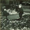 Small children playing on a seesaw in the snow, The University of Iowa, January 1938