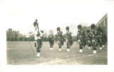 Scottish Highlanders standing in formation west of Armory with University Hospitals in background, The University of Iowa, 1930s
