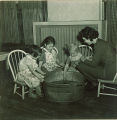 Girls and teacher with tub of water, The University of Iowa, January 1938