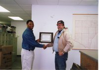 2001  Terrance Rudolph, District Conservationist,  presents Steve Nunnikhoven with a certificate for 2001 Woodland Owner of the Year