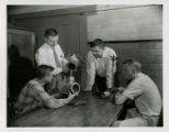 Professor Johnson discussing sprinkler irrigation equipment with students, 1957