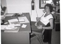 Unidentified Young Woman Sits at Desk