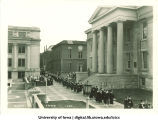 Commencement procession walking south along Old Capitol west portico, The University of Iowa, June 1930