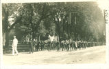 Marching band in parade near Pentacrest, The University of Iowa, 1915