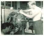 Engineering students working on airplane engine, The University of Iowa, 1950s