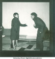 Couple in coats acting out a disagreement, 1960s