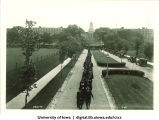 Commencement procession walking west on Iowa Avenue with Pentacrest in background, The University of Iowa, June 1929