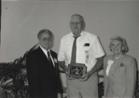 Clint Goos (middle) accepts the Outstanding Soil and Water Conservation District Commissioner Award.