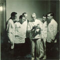 Instructor shows some dental students a small dental device, The University of Iowa, 1940s