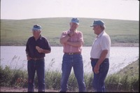 Three men near pond 