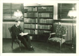Professor Ethan Allen reads in the Macbride Hall library, the University of Iowa, 1930s?