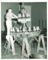 Restoring a light fixture in the Old Capitol, The University of Iowa, 1974