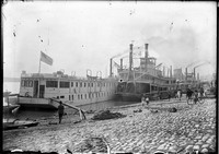 BR 213  Steamboats and barge at levee