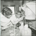 Two researchers examining equipment, 1978