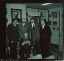 Library personnel with artifact, The University of Iowa, 1950s