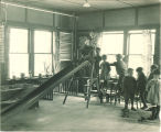 Small children playing on an indoor slide, The University of Iowa, 1920s
