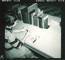 Woman with Bollinger-Lincoln books in Special Collections Dept., The University of Iowa, 1951